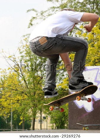 Low section view of teenage boys with skateboard