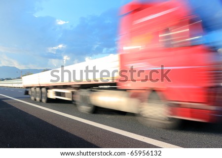 Motion blurred red truck on highway