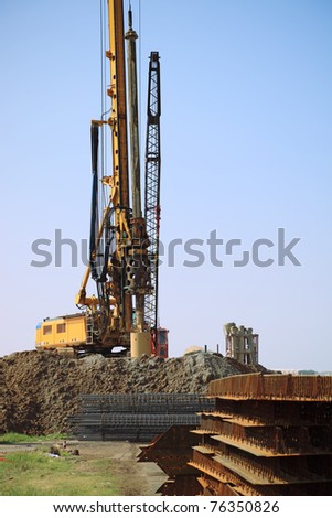 yellow drill rig on a construction site