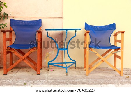 Outdoor cafe, blue chairs and tables in Athens street, Greece