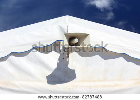 white Speaker megaphone on party, circus or fair tent