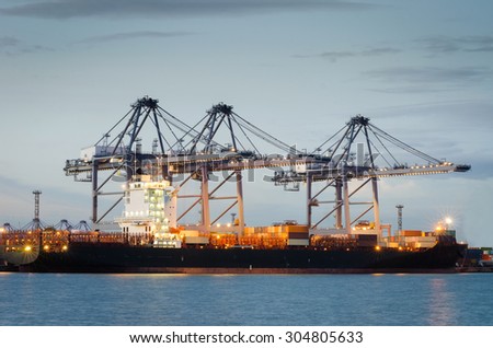 Containers loading by crane at twilight , Trade Port , Shipping , transport