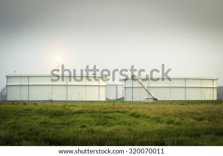 Big Industrial oil tanks - Natural Gas storage tanks - Oil Refinery factory at twilight , petrochemical plant , Petroleum , Chemical Industry