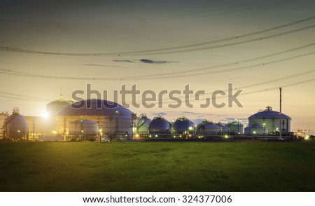 Natural Gas storage tanks and oil tank in industrial plant at twilight