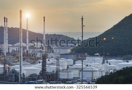 Natural Gas storage tanks and oil tank in industrial plant at sunset , Oil Refinery factory , petrochemical plant , Petroleum ,