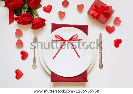 Valentine\'s day dinner. Romantic table setting with red roses. Top view.
