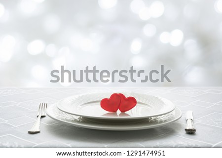 Valentines day table place setting with two hearts in cafe. Space for text. Invitation for a date.