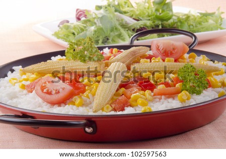 spanish vegetable paella with bell pepper, sweet corn and pea