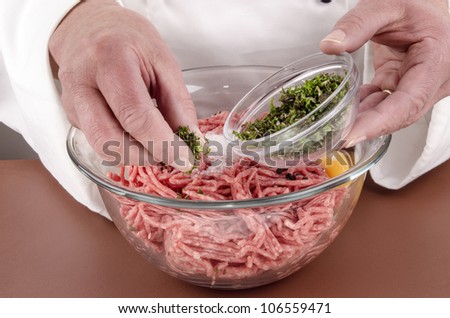 minced meat and herbs that are needed to make meat balls
