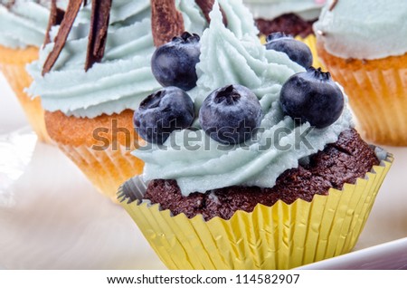 home made cupcake with blue butter cream and blueberries