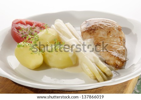 white asparagus with potato, chicken meat, tomato and cheese sauce