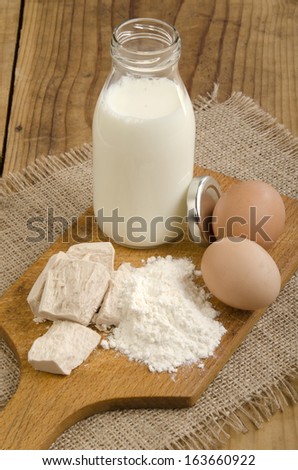 baking ingredients, milk, flour, organic eggs and fresh yeast