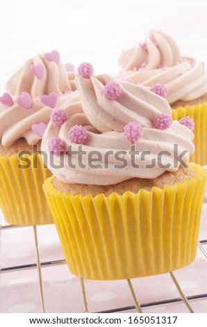 home made vanilla cupcake with pink sugar balls