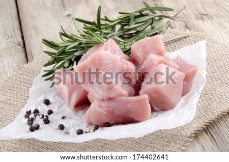 pork meat with pepper, salt and rosemary on kitchen paper