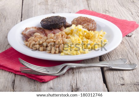 irish breakfast with black and white pudding on a white plate