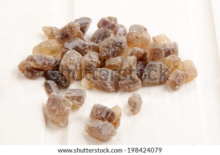 brown candy rock sugar on white wood