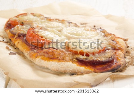 spicy flat bread pizza with tomato, salami and cheese