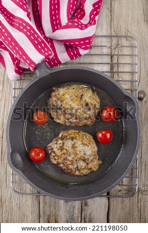 home made black pudding boxty in a cast iron pan with cherry tomato