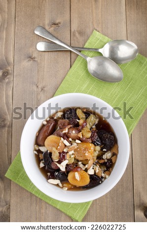 dried fruit compote with almond sliver and spoon