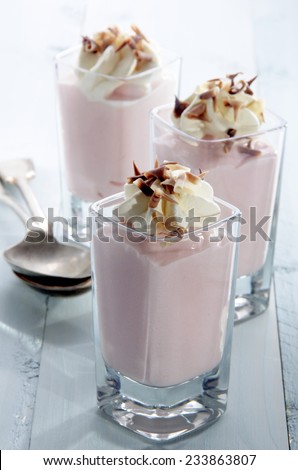 strawberry mousse with whipped cream and chocolate curls