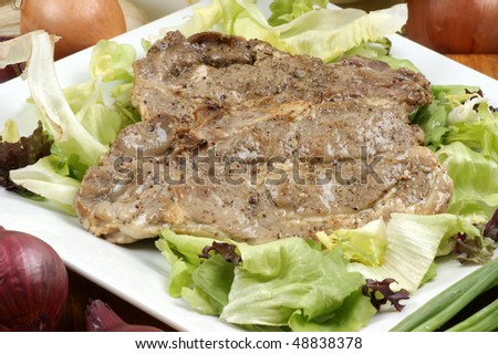 some raw organic pork chop and salad
