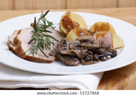 some roast pork with potato and mushrooms
