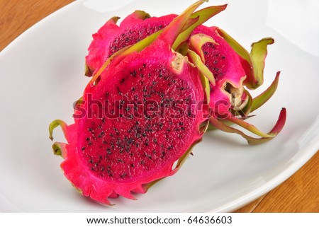 red organic dragon fruit on a white plate