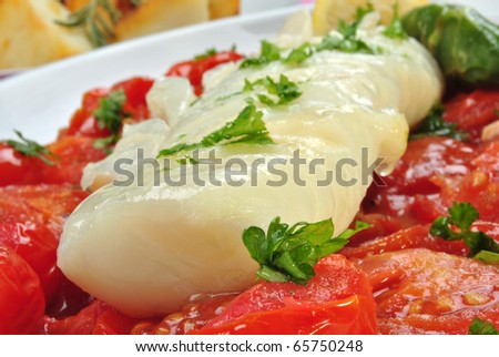 cod loins with organic tomato on a plate