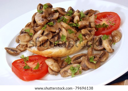 fried mushrooms on half a bun with tomato