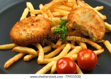 Fish Burger with fried chips on a pan