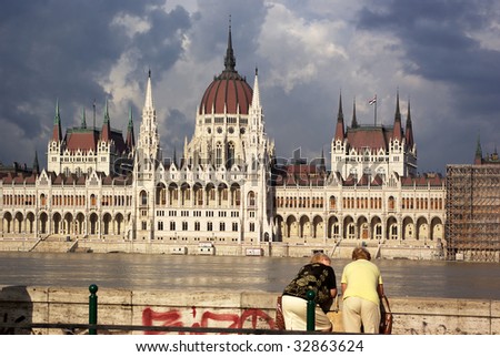 BUDAPEST, HUNGARY - June 28: Unnamed old women watch the flood of Danube and Hungarian Parliament in Batthany square, June 30, 2009 in Budapest, Hungary