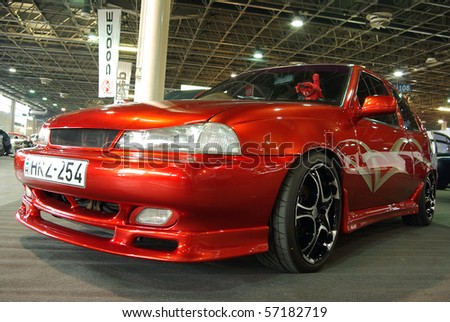 BUDAPEST - MARCH 19: Special painted red tuned car with custom light-alloy wheels on international tuning show in Hungexpo on March 19, 2010 in Budapest, Hungary