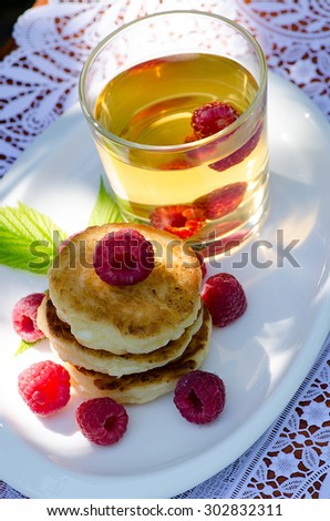 pancakes with raspberries and drink, top view
