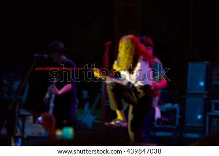 Blurred image of singer on stage in free night concert