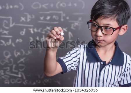 schoolboy writing math formula on  blackboard.asian grade school student solving a geometry problem on chalkboard in math class, film grain tone