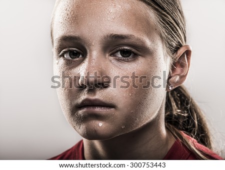 Closeup of edgy softball girl looking tough with sweat