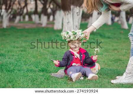 Happy Woman And Child In The Blooming Spring Garden.child Kissing Woman. Mothers Day Holiday Concept