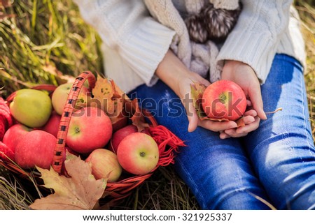 Basket with apples and woman hold apple