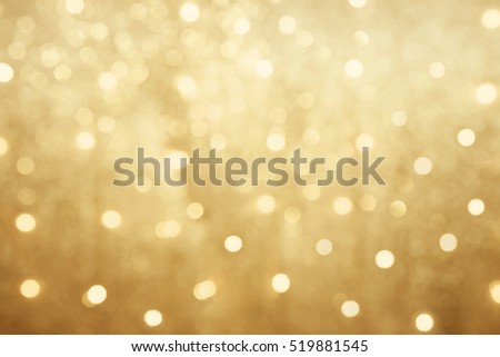 Golden beautiful blurred bokeh background with copy space. Holiday texture. Wallpaper. Glitter light spots on golden background, defocused