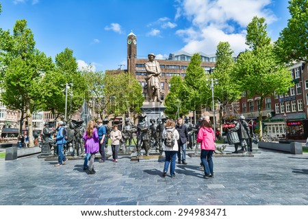 AMSTERDAM - MAY 28, 2015: Monument Rembrandt on a sunny day. Dutch artist, painter and engraver, the great master of chiaroscuro, the largest representative of the golden age of Dutch painting