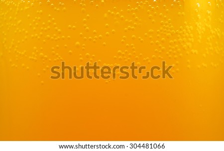 bubbles in an orange drink closeup