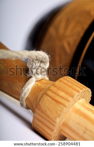 Close up of the balero stick with special focus in the rope knot
