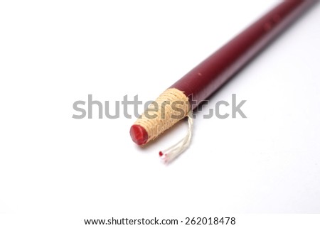 leaning red pencil with special focus in the red tip
