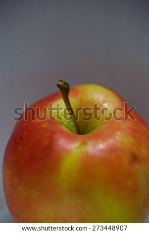 Red apple close up, with special focus in the stem texture and length