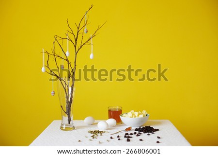 Orthodox Easter traditional bread Kulich, Panettone baking products with easter eggs decoration on a branch