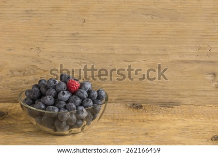 Fresh blue berry's and one isolated raspberry.