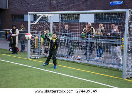 DEN HAAG, THE NETHERLANDS, MAY 02-05-2015 - kids from the soccer club Haagse voetbal vereniging RAS are playing a match against Duno. The children from the club RAS won the game.