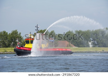 Port of Amsterdam, Noord-Holland/Netherlands - June 25-06-2015 - PA4 is using his water canons at the noordzeekanaal. PA4 (Port of Amsterdam 4) also known as the port authorities. (Photo nr. 3)