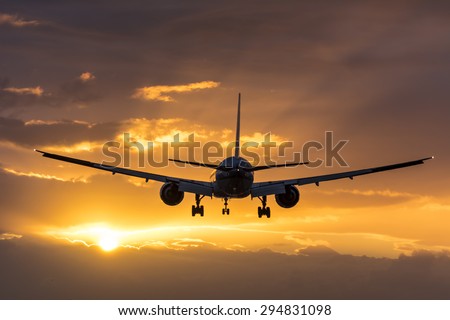 Plane flying towards the morning sun.