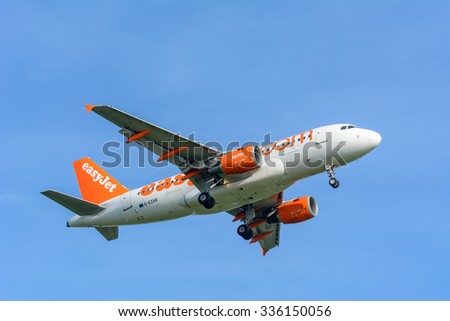 Schiphol, Noord-Holland/Netherlands- October 31-10-2015 -Plane from easy jet G-EZAB Airbus A319-100 is started landing at Schiphol Airport. Nice blue sky at the background of the Airplane.